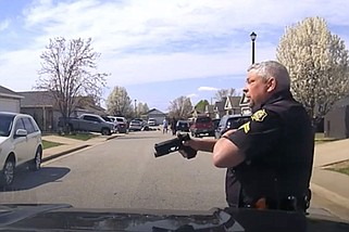 Screenshot from dash camera video showing Cpl. Danny Wright approach a suspect wielding a knife. (Courtesy Springdale Police Department)